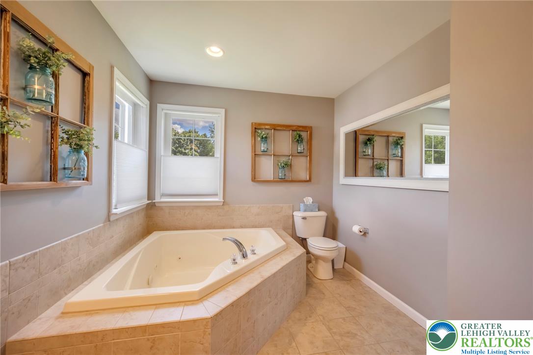 204 Bushkill Ridge Road Wind Gap, PA 18091 - Photo 27 of 48 Relax in this inviting bathroom featuring a deep soaking tub, perfect for unwinding after a long day.