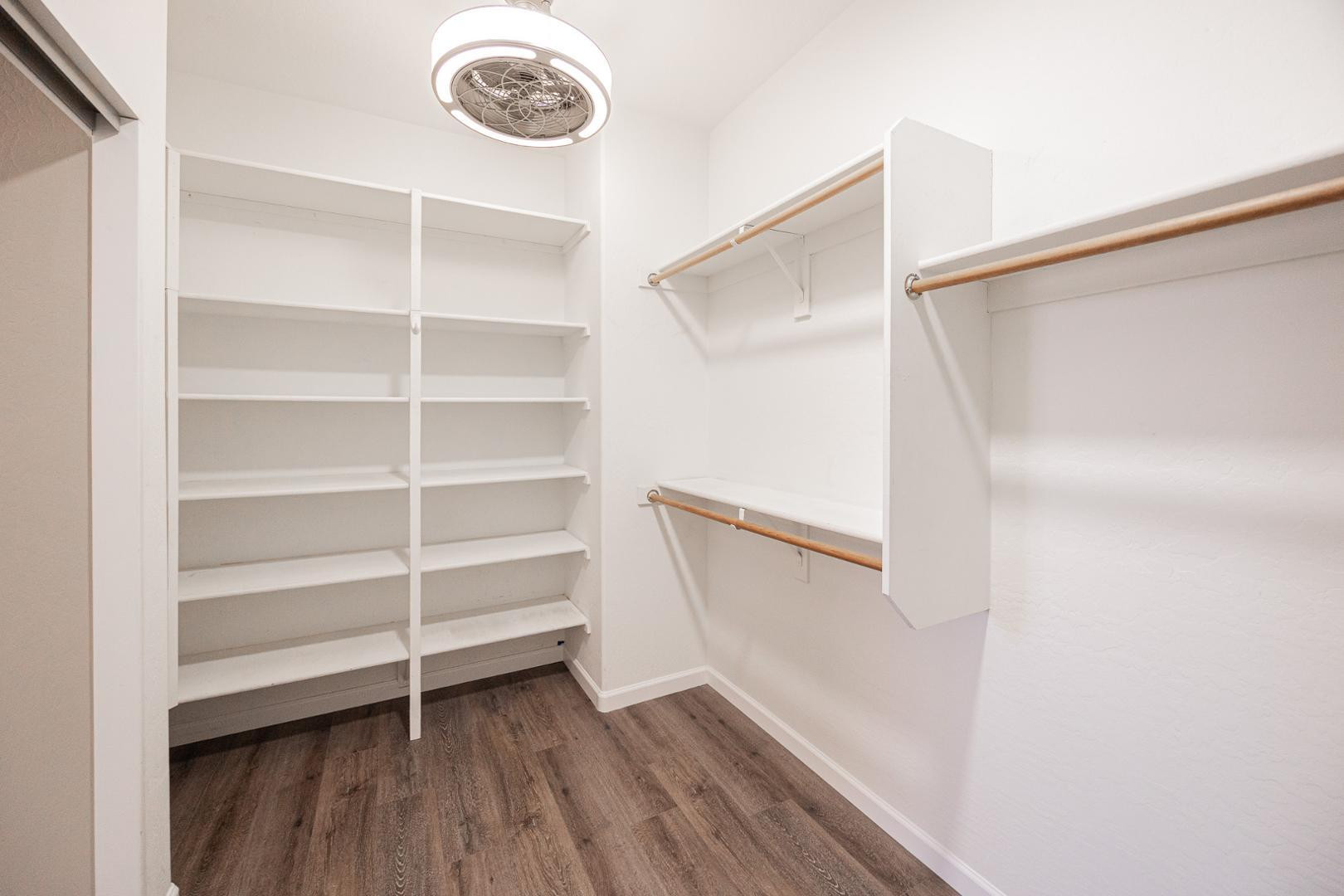 6539 West Jomax Road Phoenix, AZ 85083 - Photo 23 of 39 a view of walk in closet with empty racks