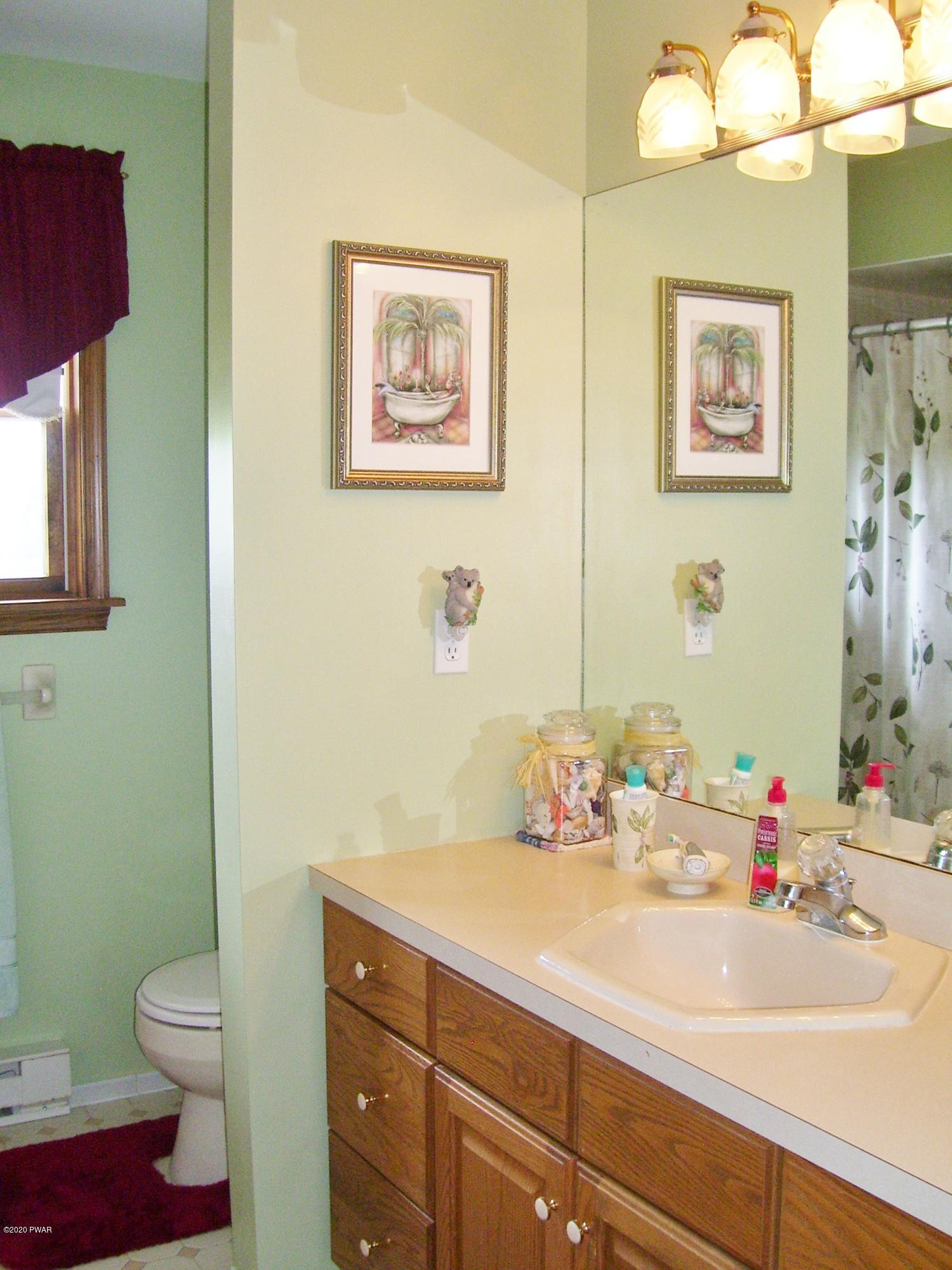 50 Layton Road Waymart, PA 18472 - Photo 33 of 61 a bathroom with a sink mirror vanity and toilet