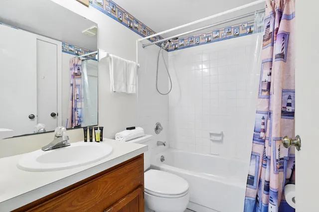 a bathroom with a sink toilet tub and shower