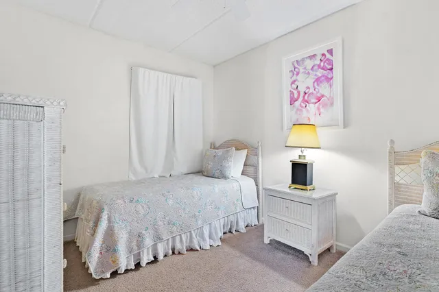 a bedroom with a bed and painting on the wall