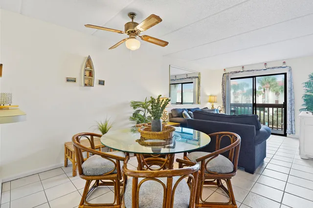 a view of a dining room with furniture and a potted plant