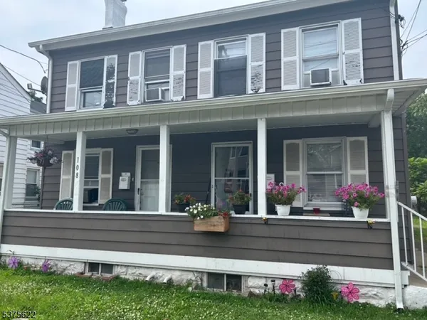 front view of a brick house with a yard
