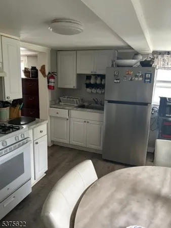 a kitchen with a refrigerator stove and microwave