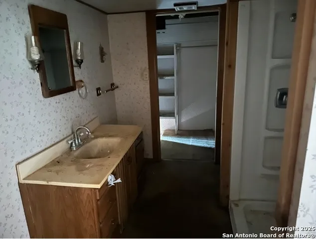 a bathroom with a sink and mirror