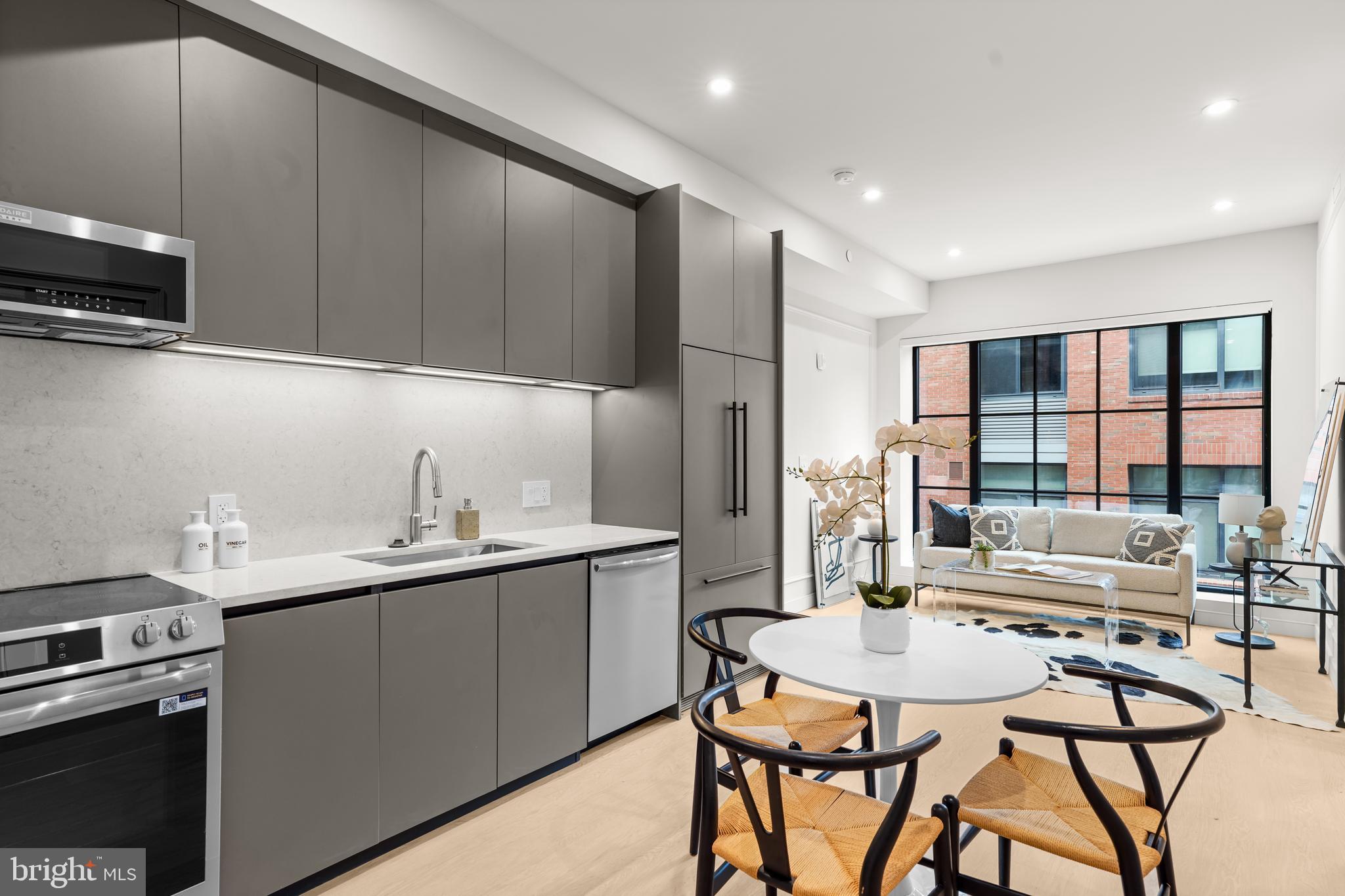 a kitchen with stainless steel appliances kitchen island granite countertop a sink and cabinets