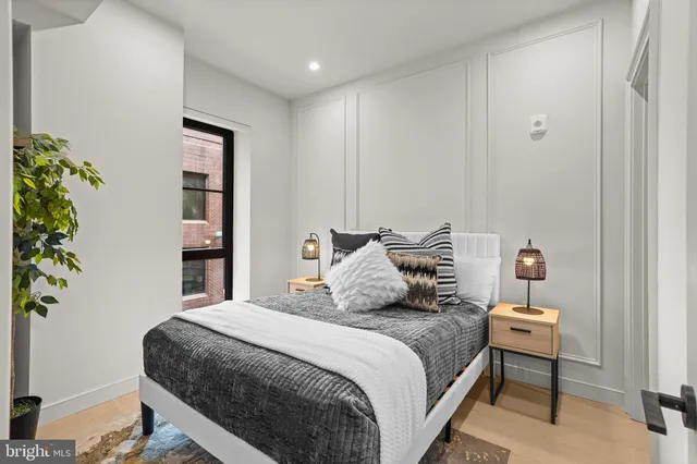 a bedroom with a bed and a potted plant