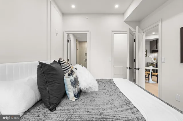 a bedroom with a bed and a mirror