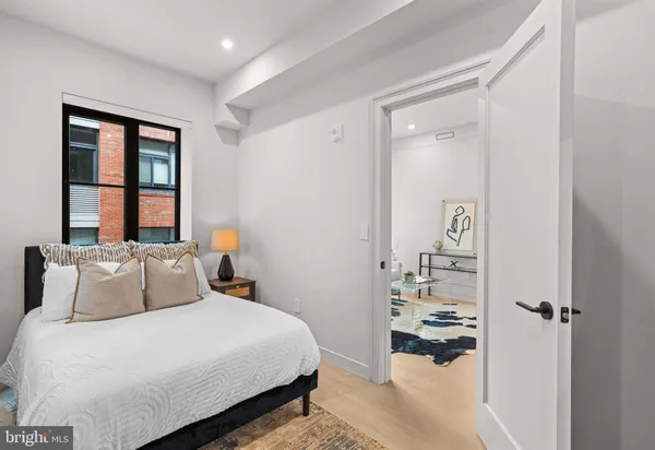 a bedroom with a bed and a window