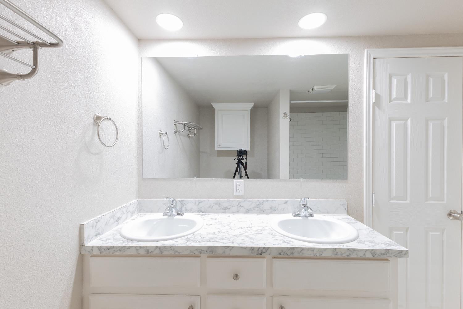 506 40th Street Lubbock, TX 79404 - Photo 14 of 17 a bathroom with a granite countertop sink and a mirror