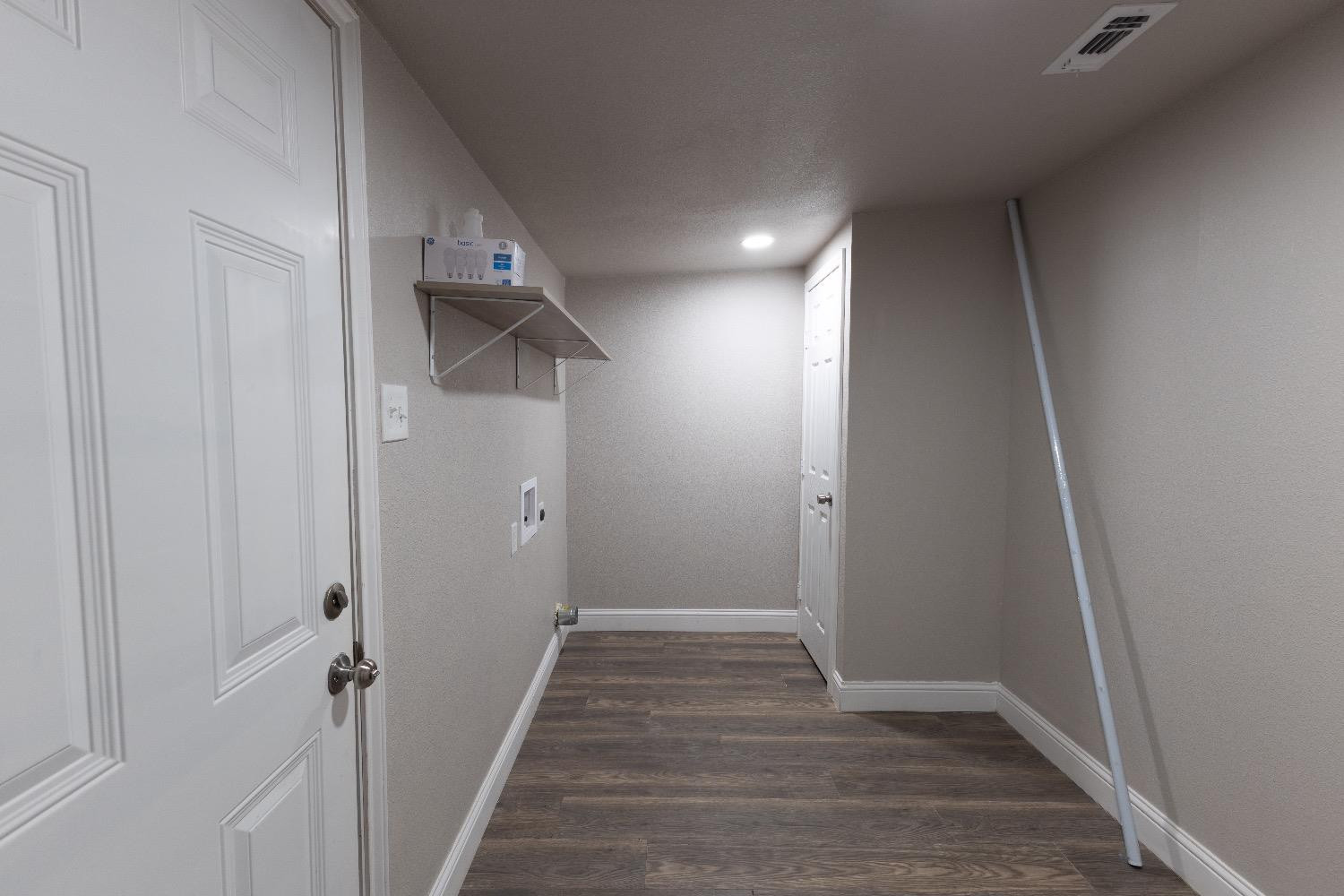 506 40th Street Lubbock, TX 79404 - Photo 16 of 17 a view of a hallway with wooden floor and staircase