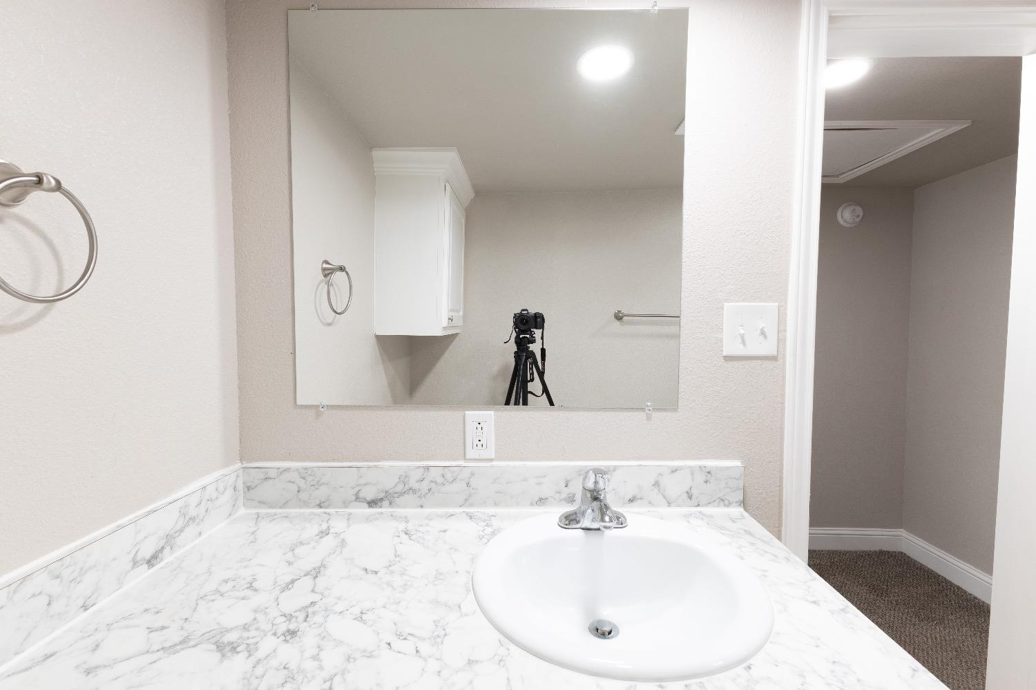 506 40th Street Lubbock, TX 79404 - Photo 9 of 17 a bathroom with a sink and a mirror