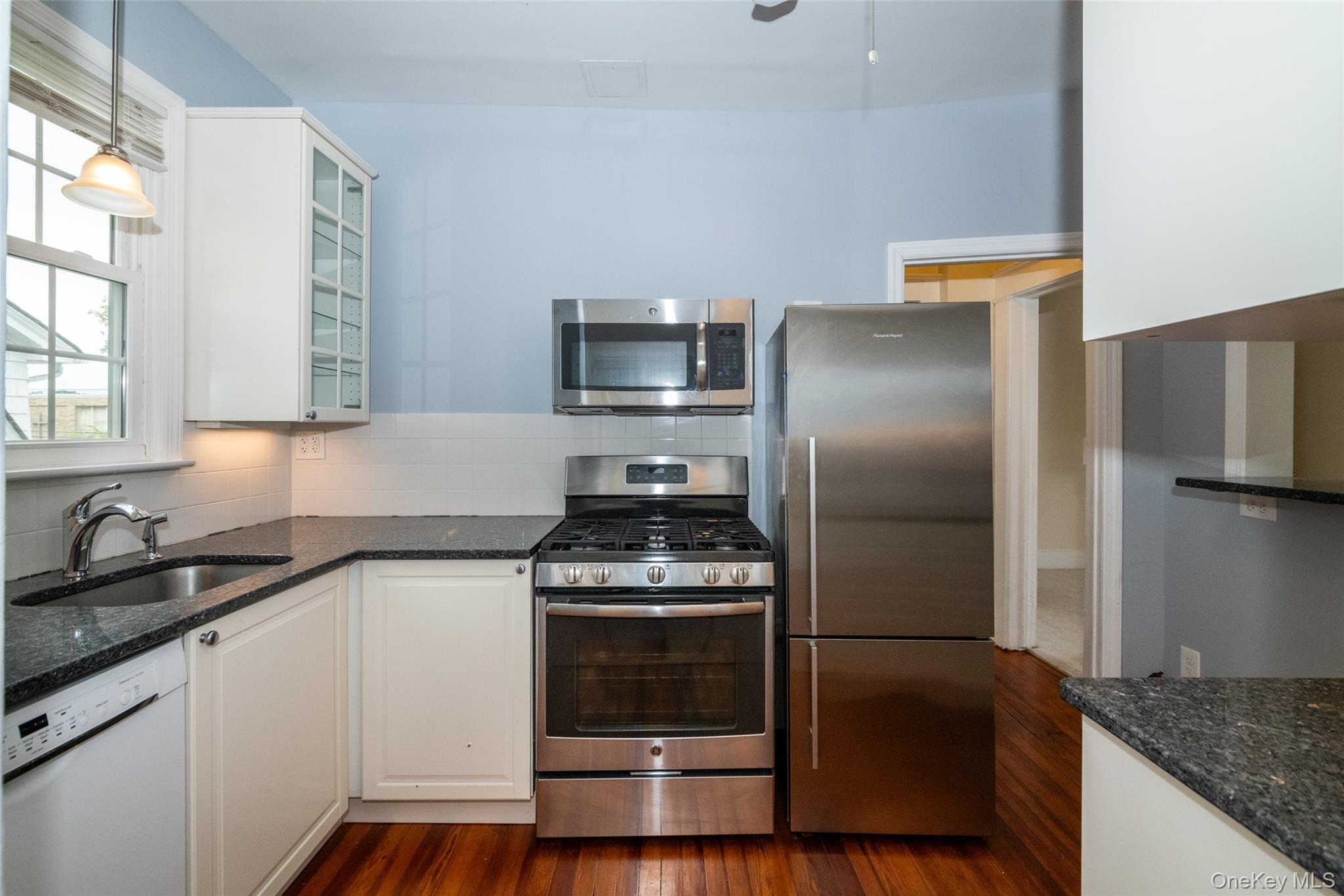 82 Clove Road New Rochelle, NY 10801 - Photo 12 of 39 a kitchen with a sink stove and refrigerator