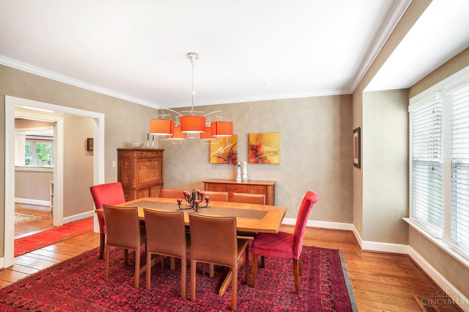 2780 Walsh Road Cincinnati, OH 45208 - Photo 21 of 68 The beautifully appointed formal dining room is designed for both everyday living and elegant entertaining. Anchored by rich hardwood floors, crown molding and a statement chandelier, the space is warm and inviting with generous proportions for hosting. Large windows bring in natural light, while seamless connectivity to adjacent living areas ensures an effortless flow for gatherings both large and small.