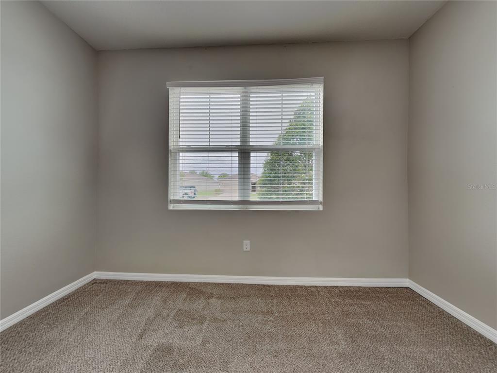 Undisclosed Address Spring Hill, FL 34609 - Photo 11 of 17 an empty room with a window
