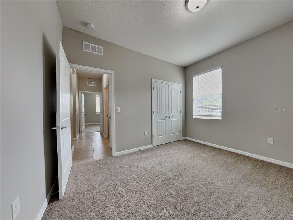 Undisclosed Address Spring Hill, FL 34609 - Photo 13 of 17 an empty room with windows and closet