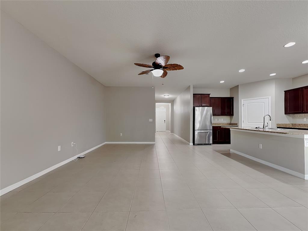 Undisclosed Address Spring Hill, FL 34609 - Photo 2 of 17 a view of an empty room with a kitchen