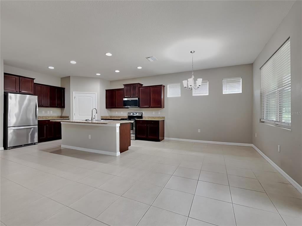 Undisclosed Address Spring Hill, FL 34609 - Photo 4 of 17 a large kitchen with cabinets and stainless steel appliances