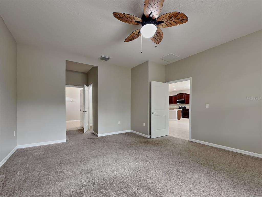 Undisclosed Address Spring Hill, FL 34609 - Photo 6 of 17 an empty room with closet and a ceiling fan