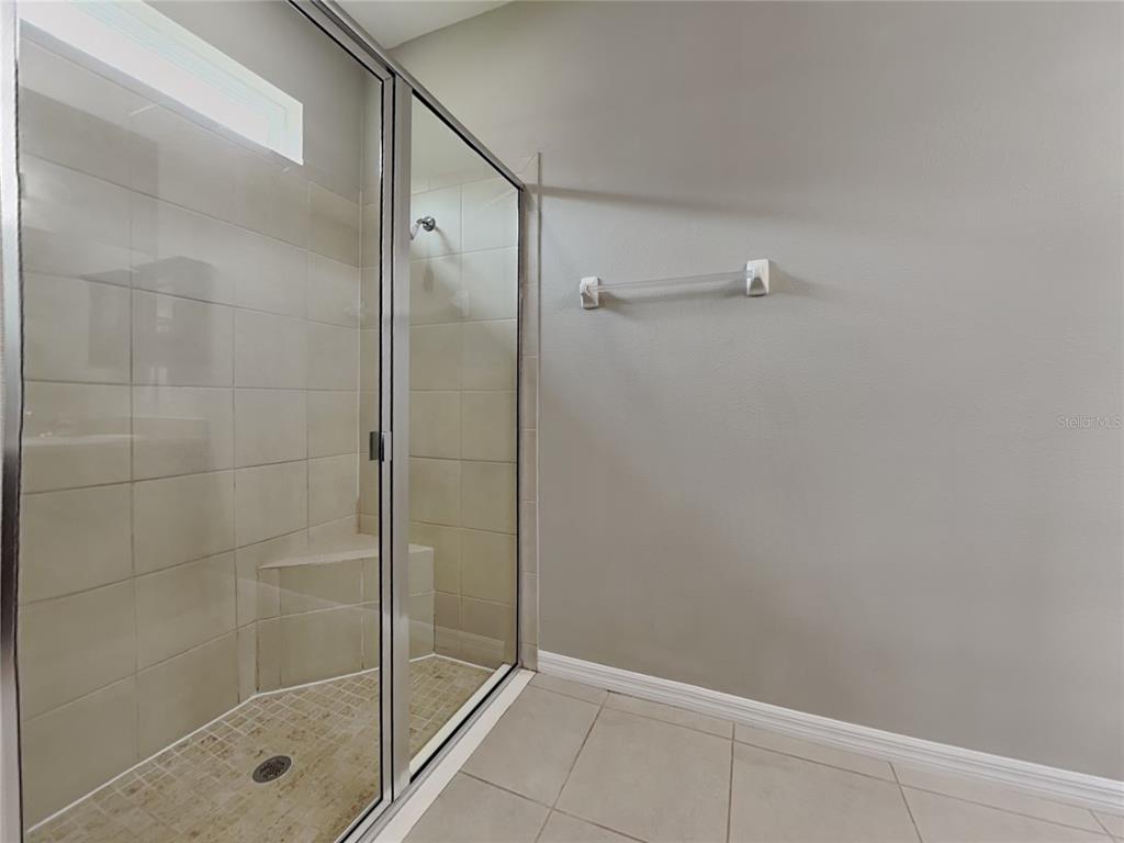 Undisclosed Address Spring Hill, FL 34609 - Photo 9 of 17 a bathroom with a glass shower door