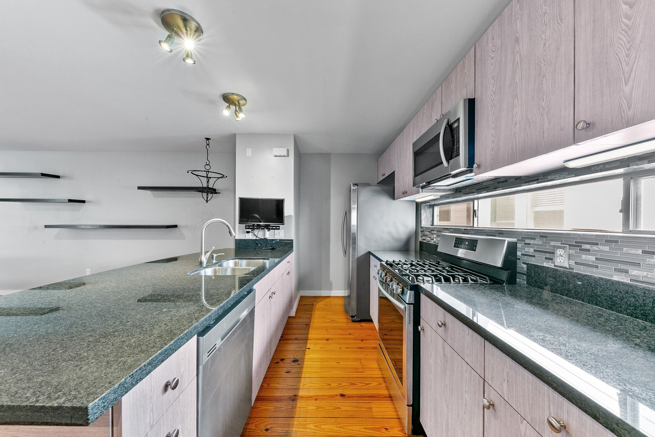 2614 Chenevert Street Houston, TX 77004 - Photo 11 of 34 a large kitchen with stainless steel appliances granite countertop a lot of counter space