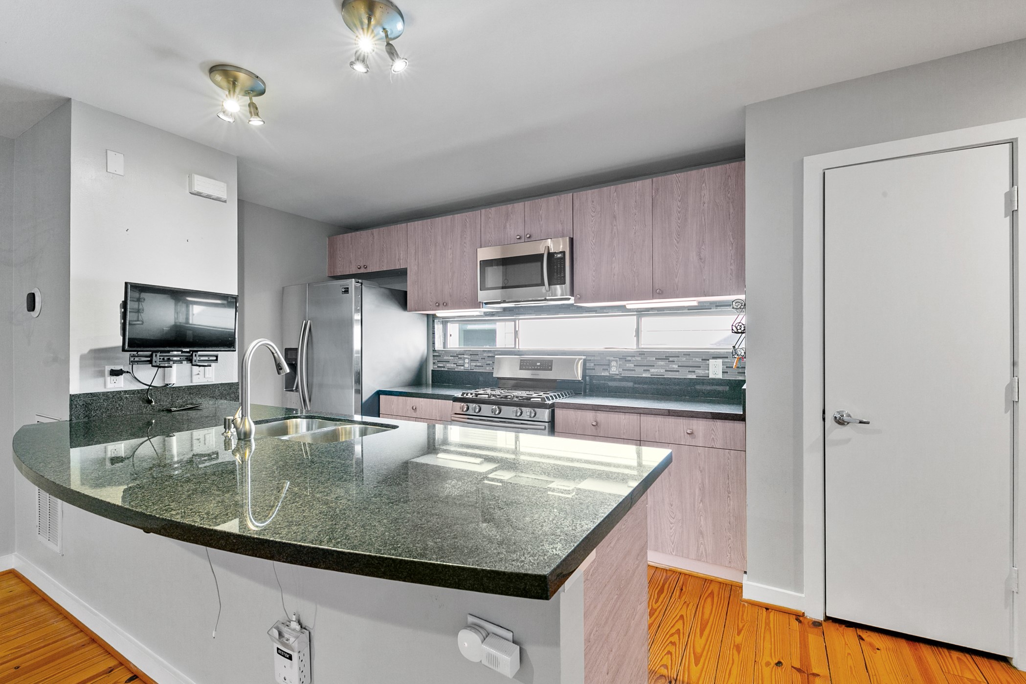 2614 Chenevert Street Houston, TX 77004 - Photo 12 of 34 a kitchen with a stove a sink and a refrigerator