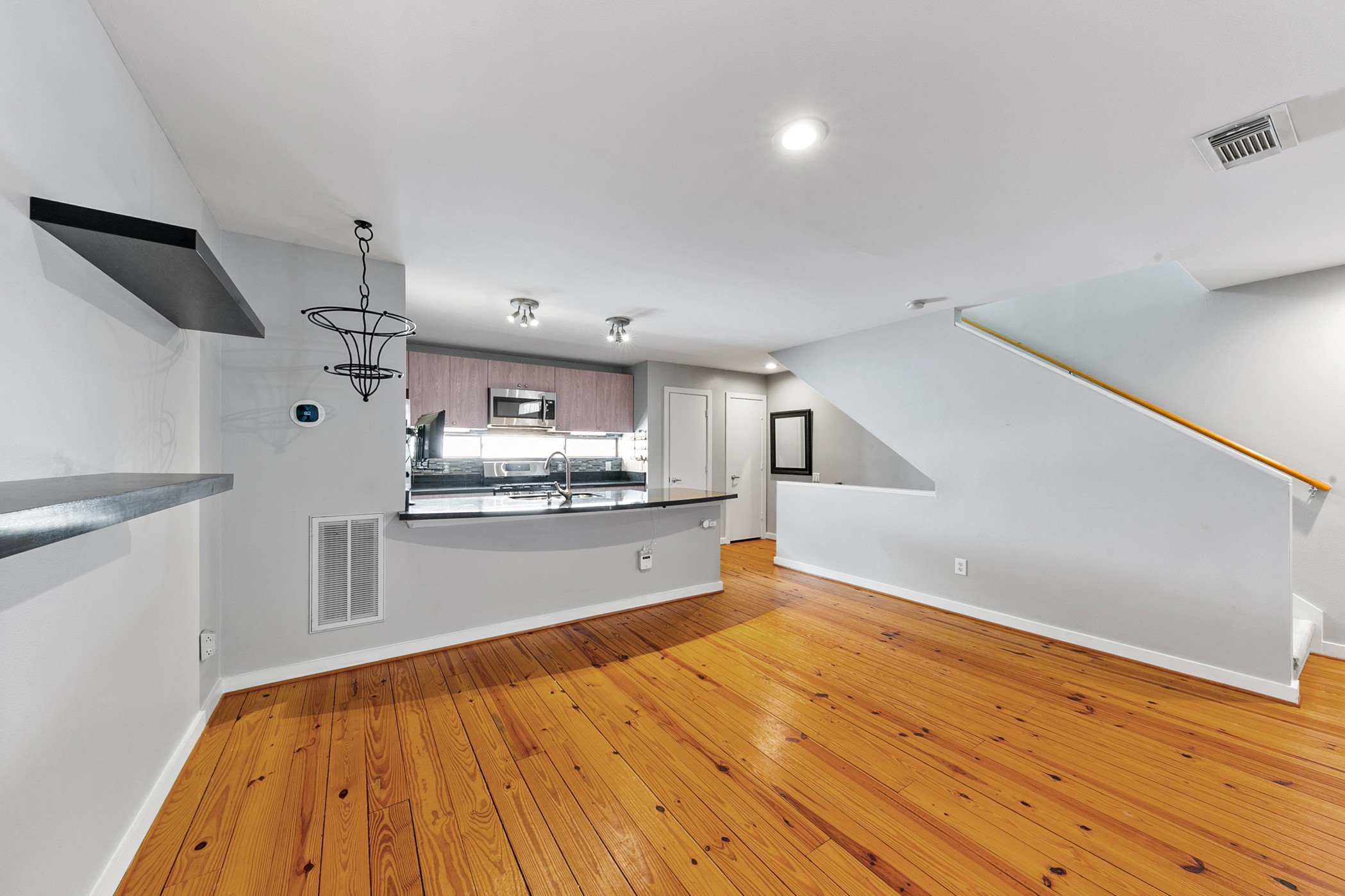 2614 Chenevert Street Houston, TX 77004 - Photo 14 of 34 a large kitchen with kitchen island a stove a sink dishwasher and wooden floor