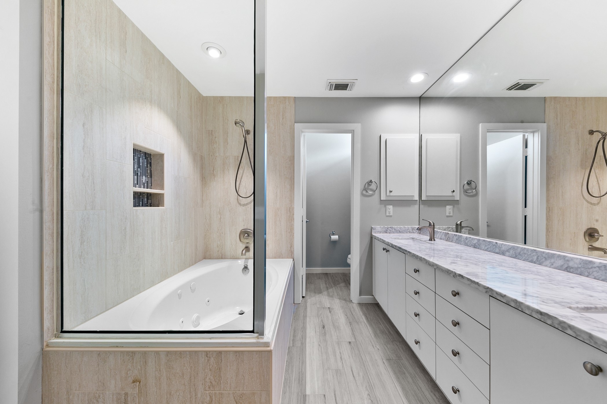 2614 Chenevert Street Houston, TX 77004 - Photo 26 of 34 a bathroom with a granite countertop sink mirror and a bathtub