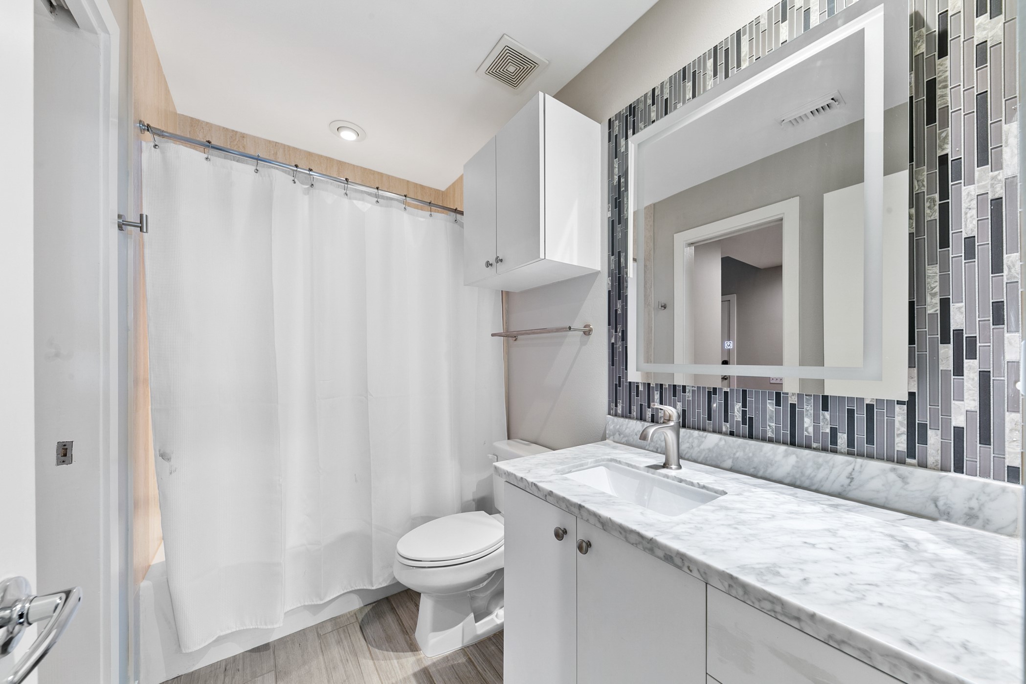 2614 Chenevert Street Houston, TX 77004 - Photo 9 of 34 a bathroom with a granite countertop sink and a mirror