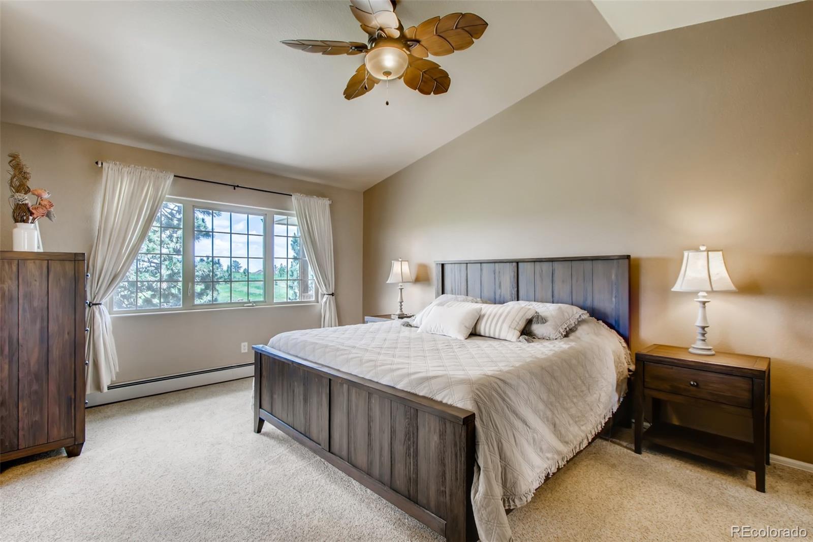 18030 Ranch Hand Road Peyton, CO 80831 - Photo 19 of 40 a bedroom with a bed and a chandelier