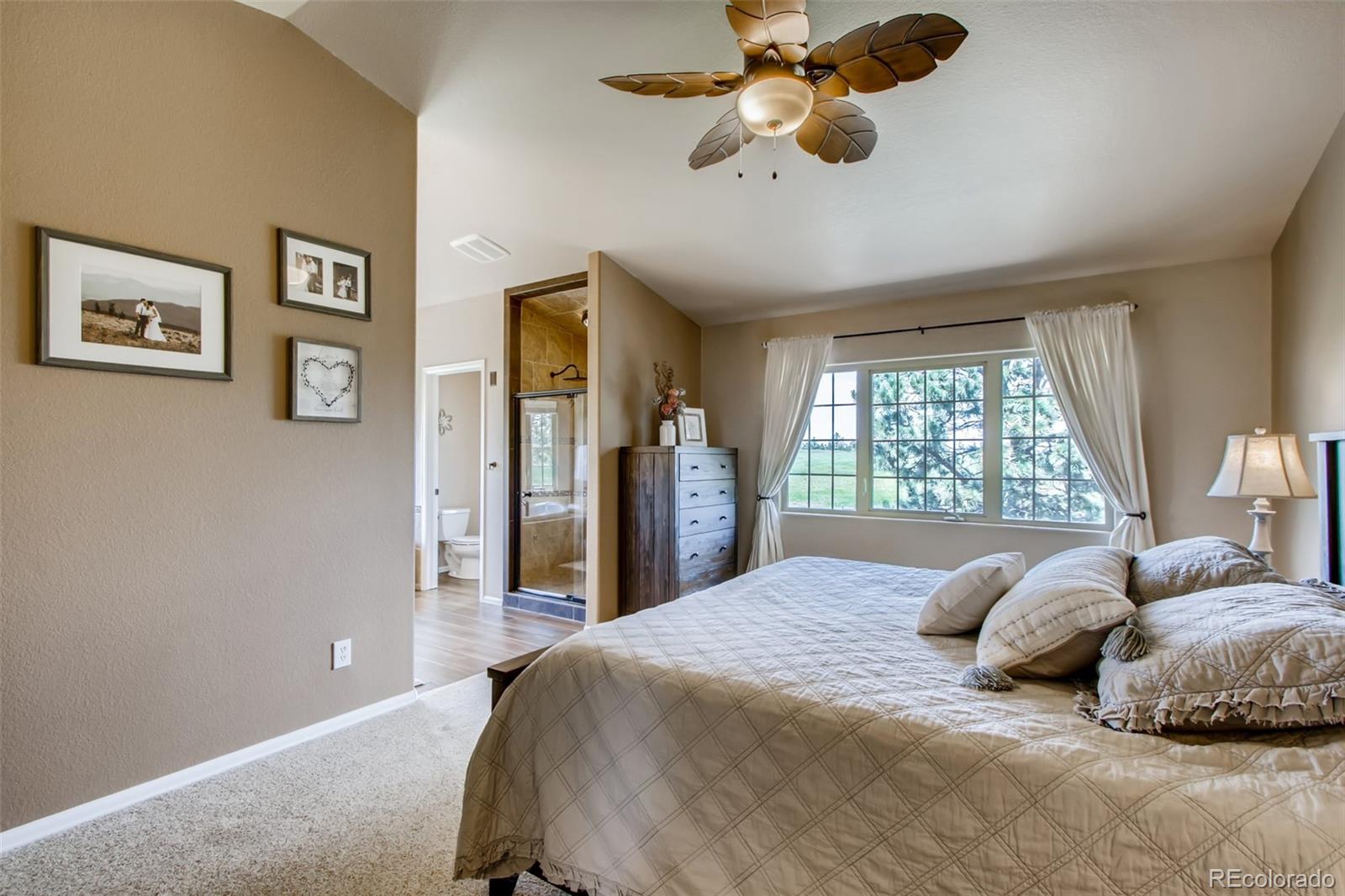 18030 Ranch Hand Road Peyton, CO 80831 - Photo 20 of 40 a bedroom with a large bed and a window