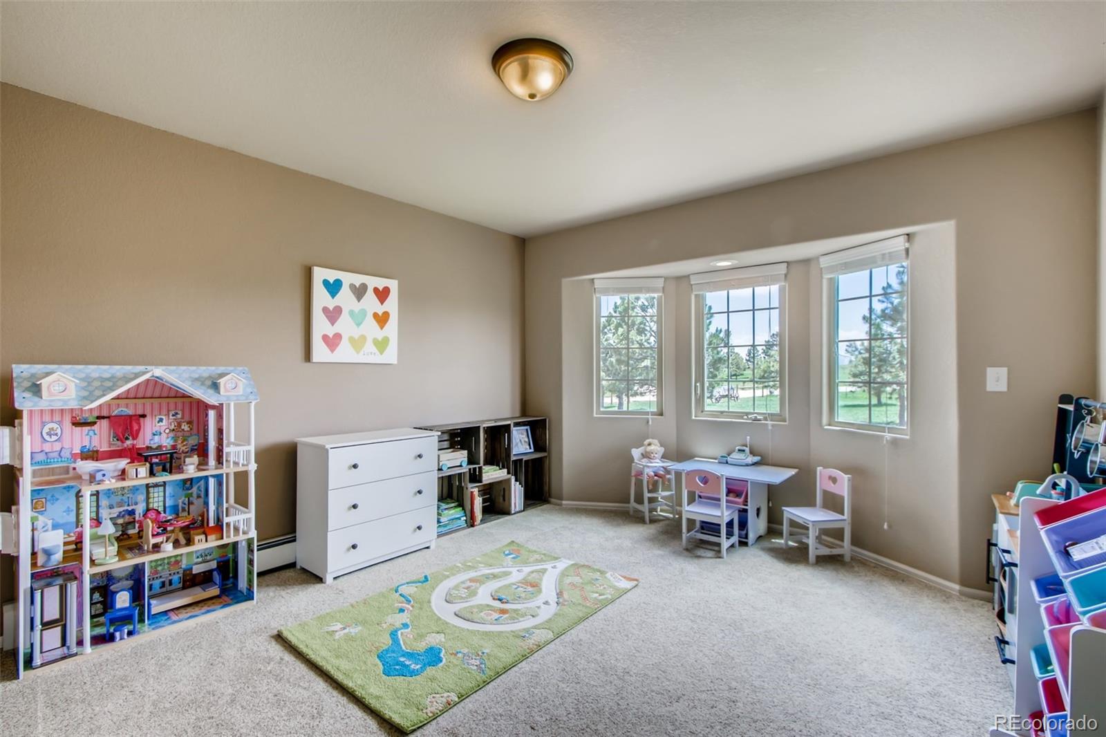 18030 Ranch Hand Road Peyton, CO 80831 - Photo 25 of 40 a bedroom with furniture and a window
