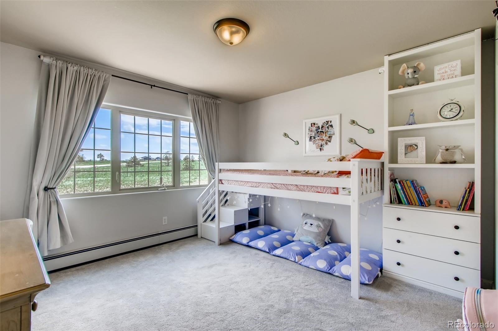 18030 Ranch Hand Road Peyton, CO 80831 - Photo 28 of 40 a bedroom with a bed and a window