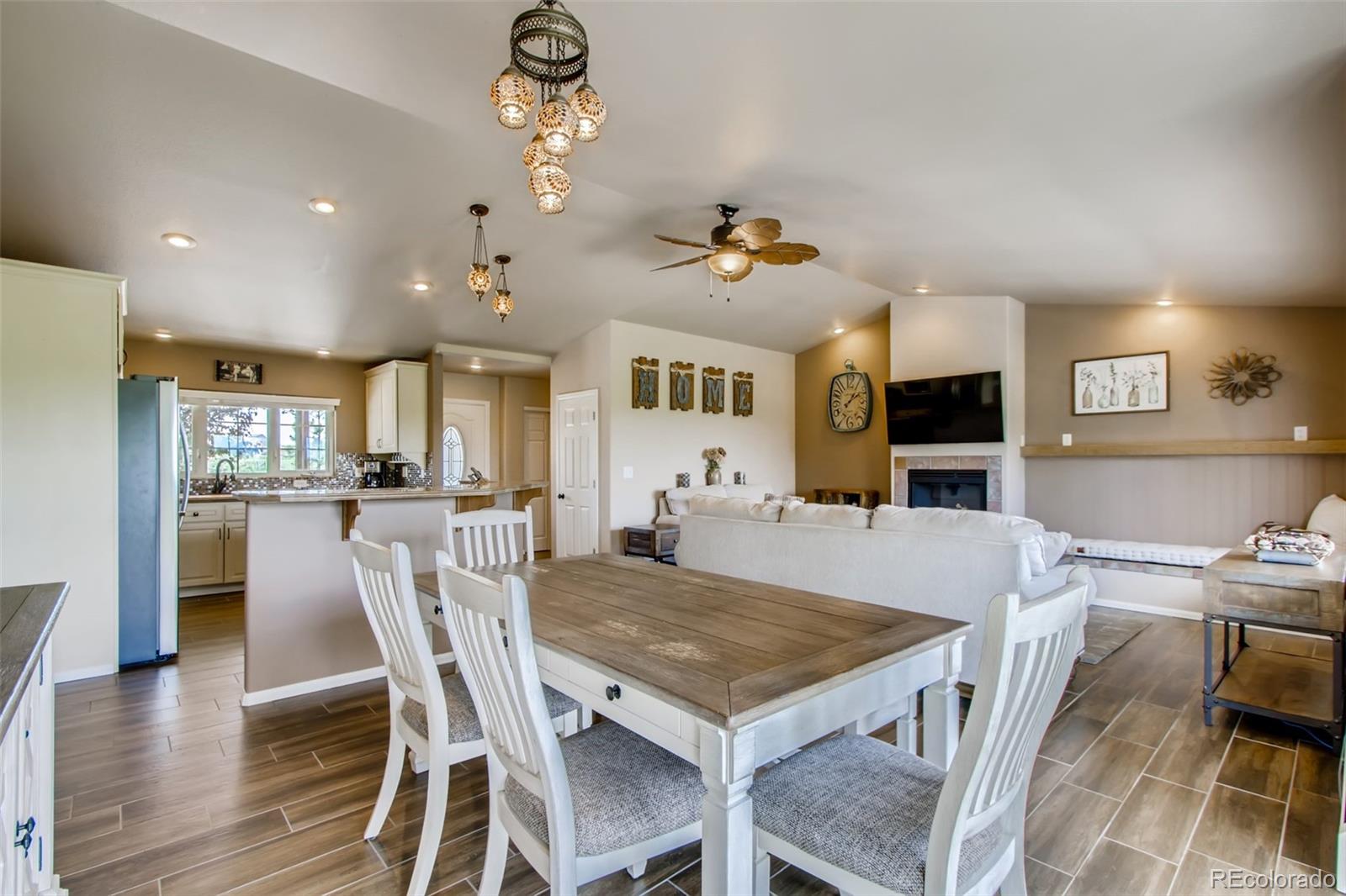 18030 Ranch Hand Road Peyton, CO 80831 - Photo 7 of 40 a view of a dining room with furniture and wooden floor
