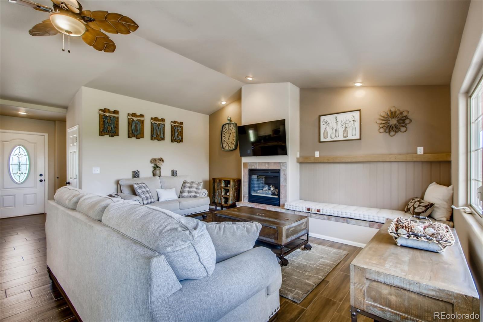 18030 Ranch Hand Road Peyton, CO 80831 - Photo 9 of 40 a living room with furniture and a fireplace