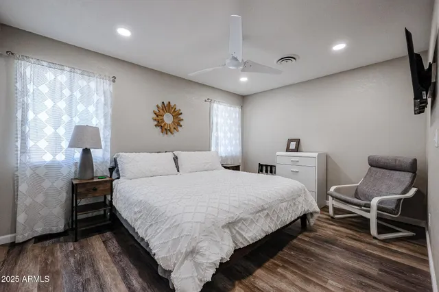 a bedroom with a bed and a flat screen tv