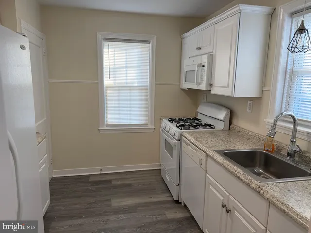 a kitchen with a sink cabinets and window