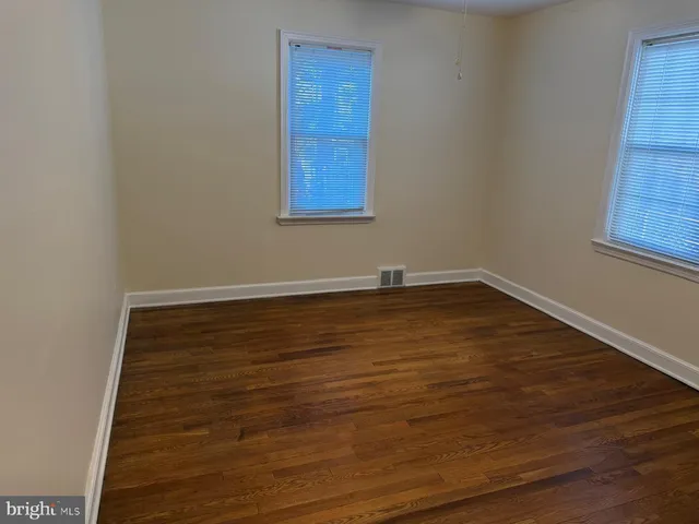 a view of room with window and hardwood floor