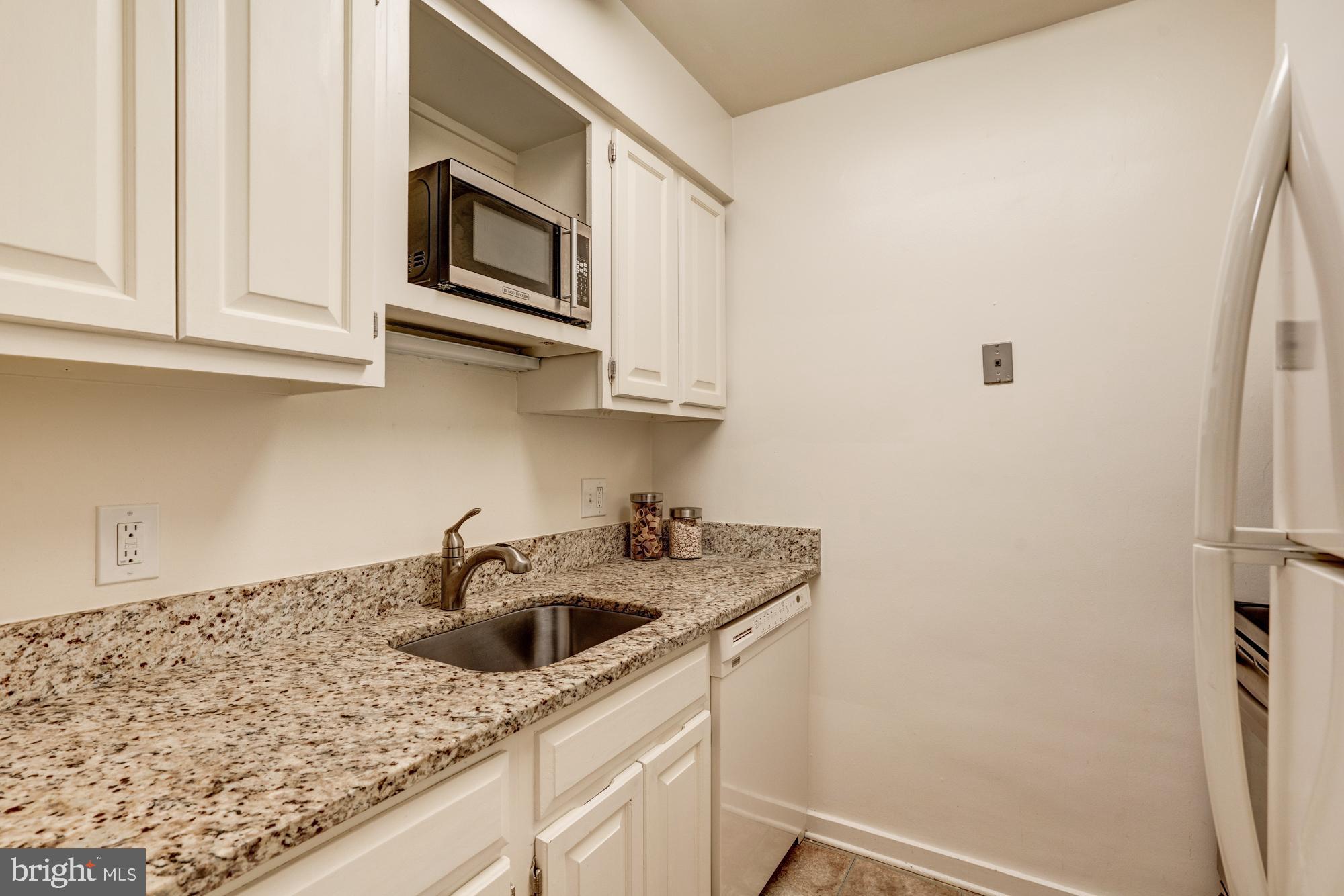 8205 Grubb Road, Unit G202 Silver Spring, MD 20910 - Photo 5 of 38 EFFICIENTLY DESIGNED KITCHEN W/GRANITE COUNTERS