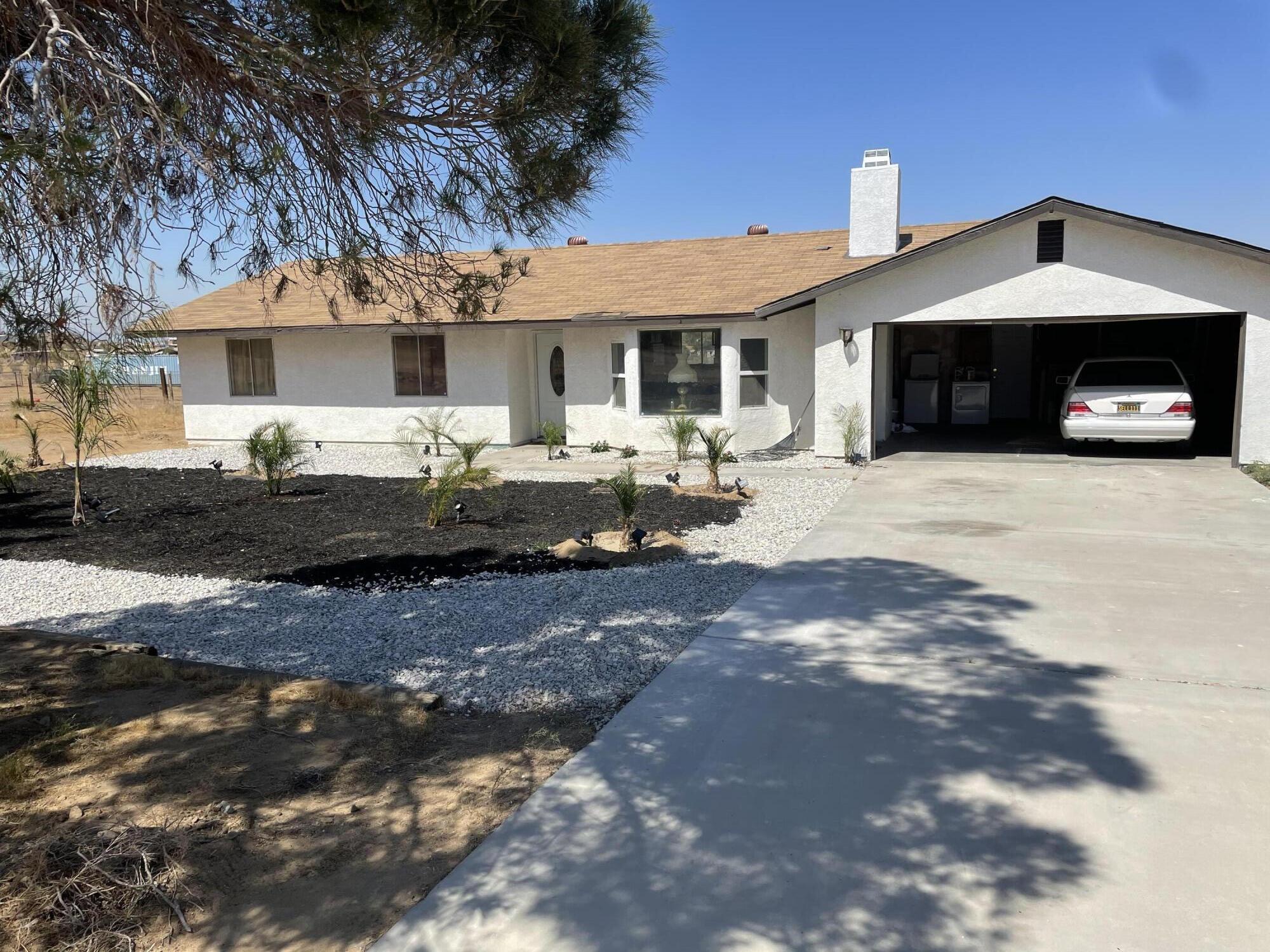 14818 Desert Star Road Apple Valley, CA 92307 - Photo 1 of 10 a front view of a house with cars parked