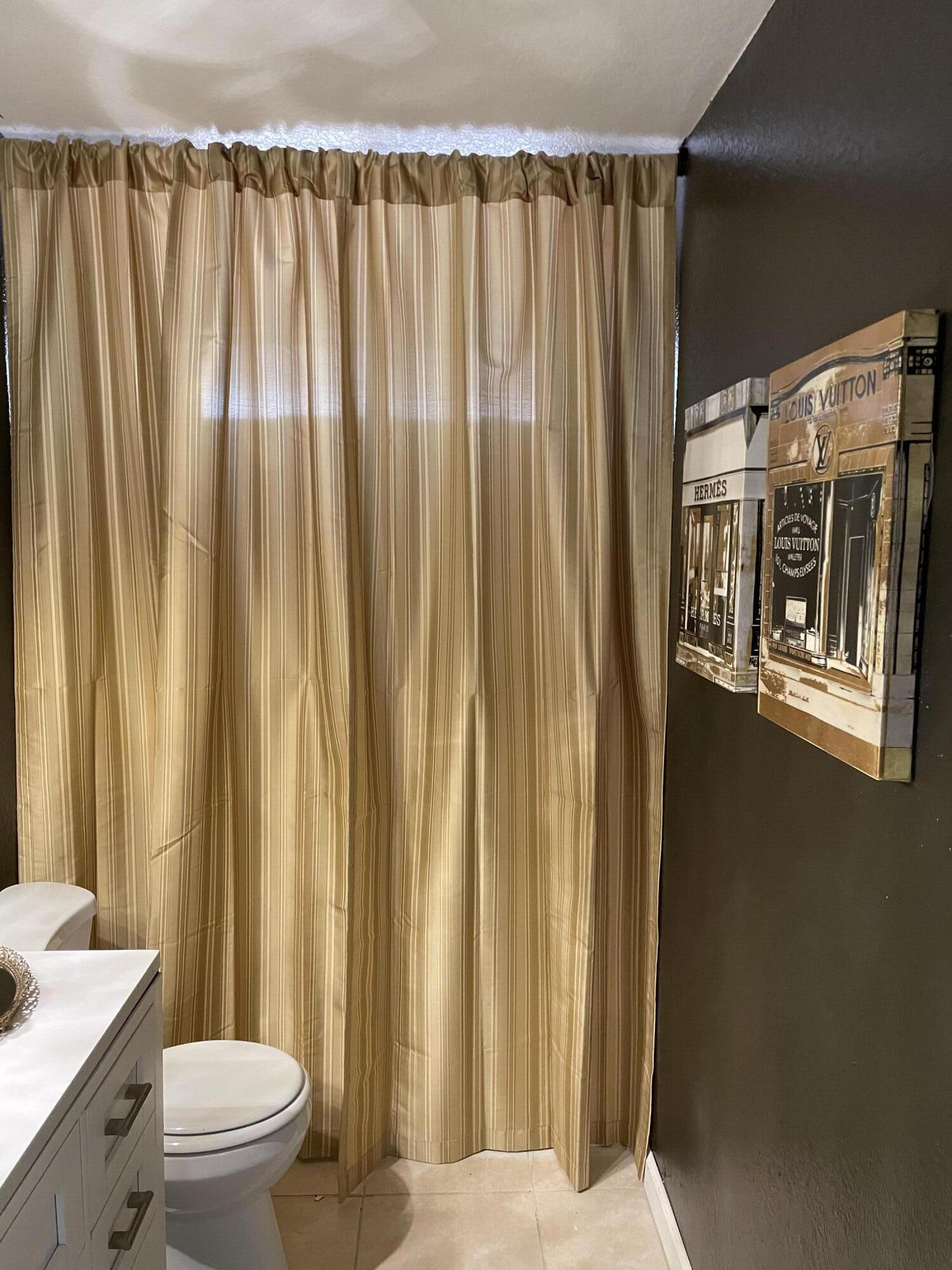 14818 Desert Star Road Apple Valley, CA 92307 - Photo 3 of 10 a bathroom with a shower curtain and a toilet