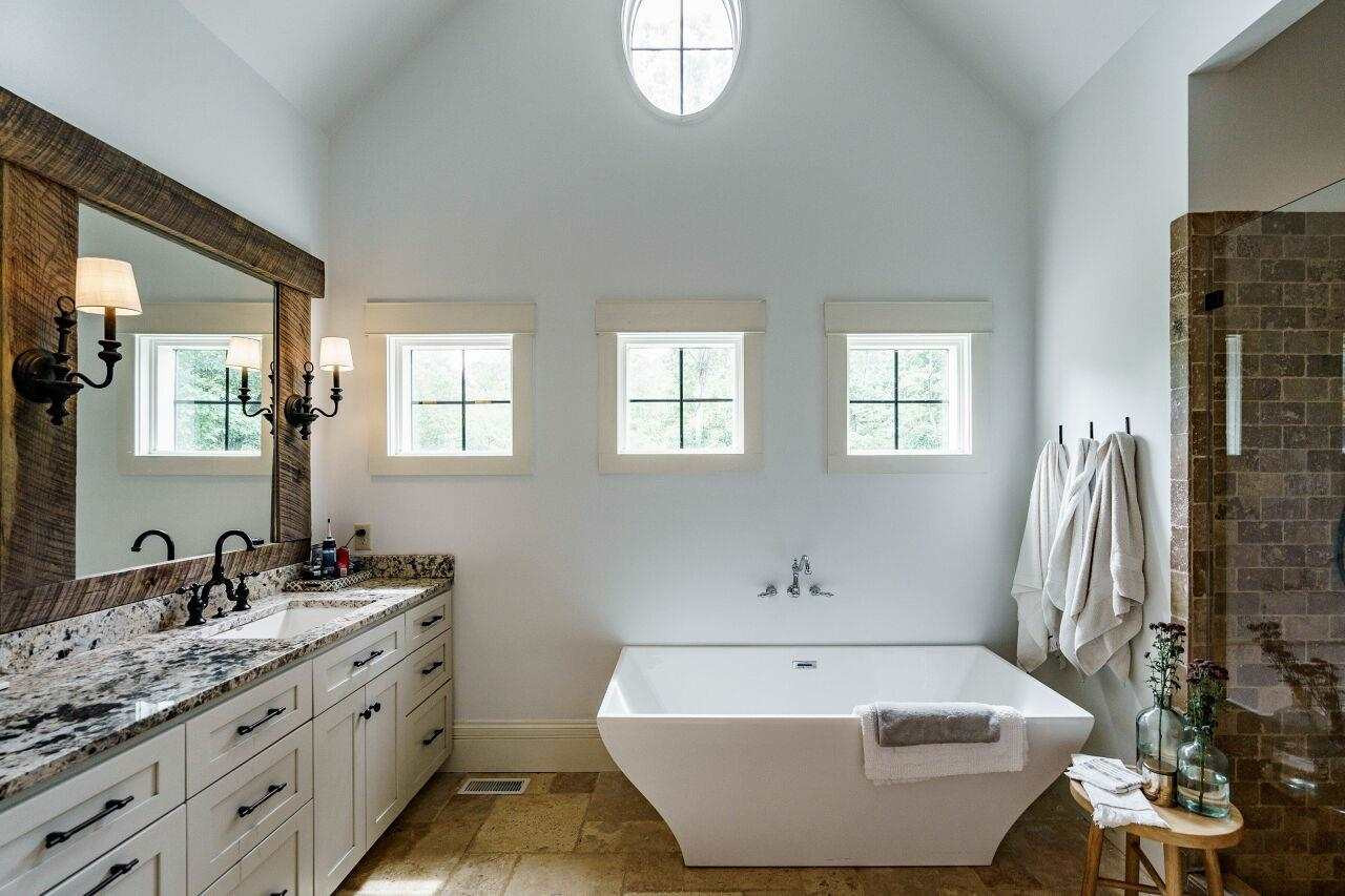 4709 Bountiful Lane Apex, NC 27539 - Photo 11 of 30 a bathroom with a tub sink and mirror