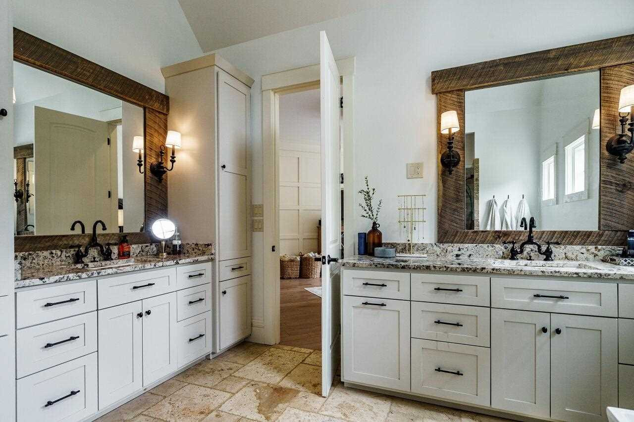 4709 Bountiful Lane Apex, NC 27539 - Photo 12 of 30 a spacious bathroom with a granite countertop sink and a mirror