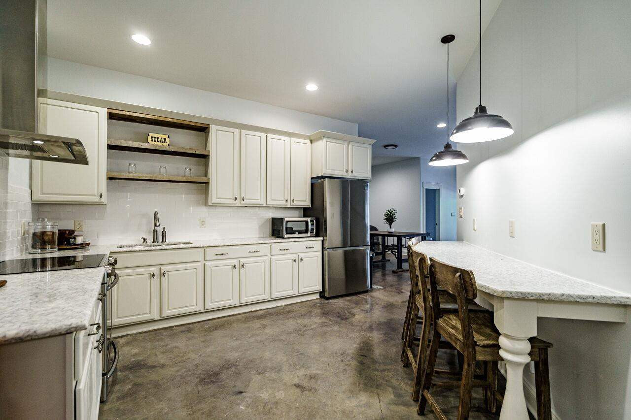 4709 Bountiful Lane Apex, NC 27539 - Photo 20 of 30 a kitchen with a table chairs microwave and cabinets