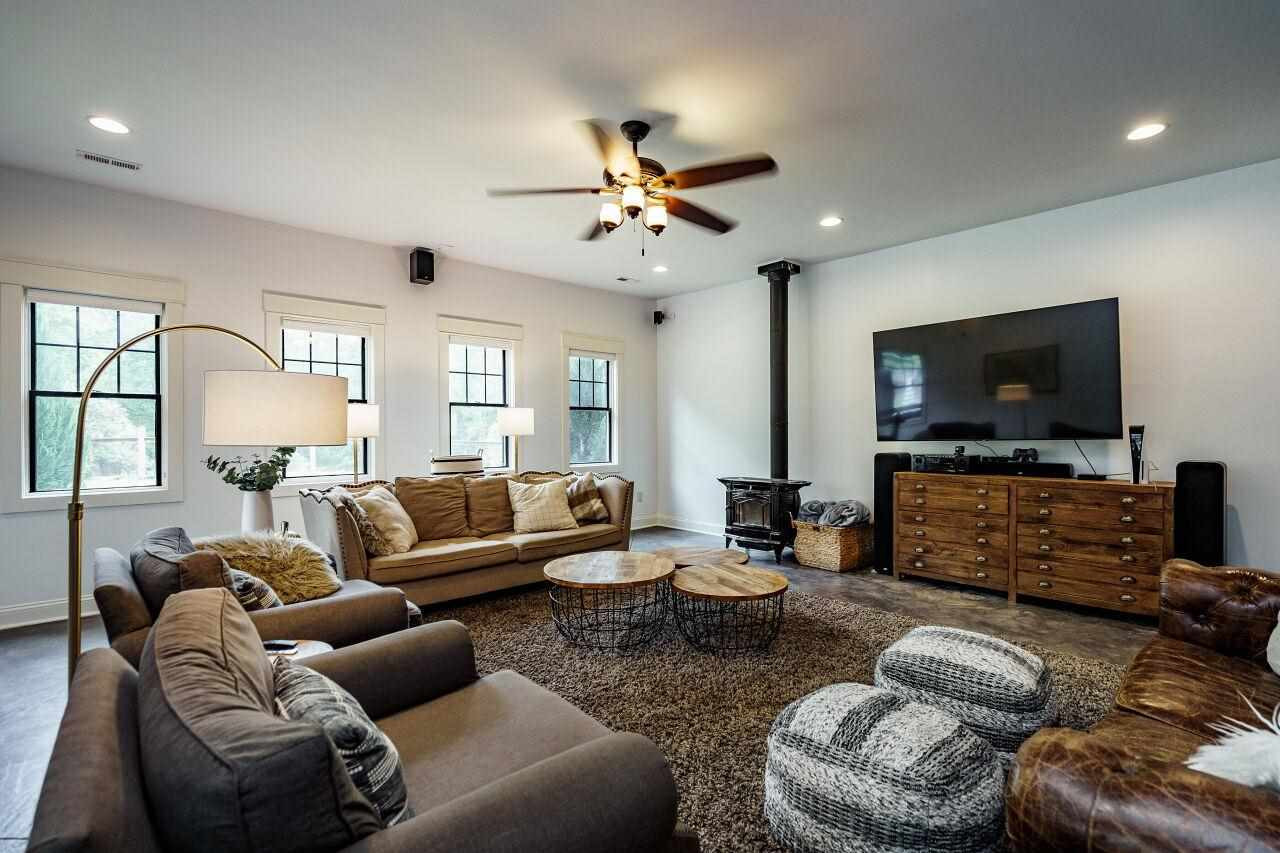 4709 Bountiful Lane Apex, NC 27539 - Photo 22 of 30 a living room with furniture and a flat screen tv