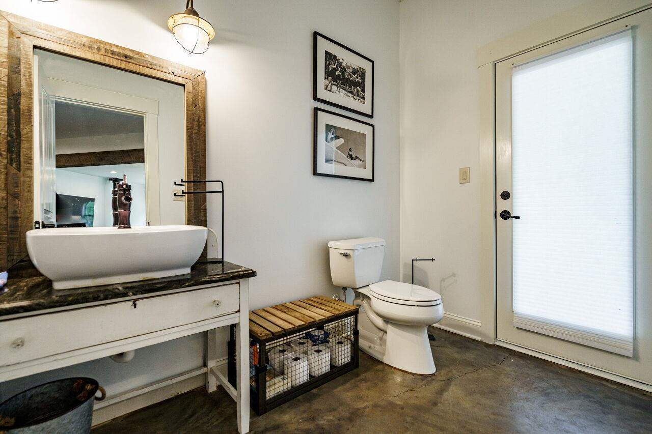 4709 Bountiful Lane Apex, NC 27539 - Photo 23 of 30 a bathroom with a toilet a sink and a mirror