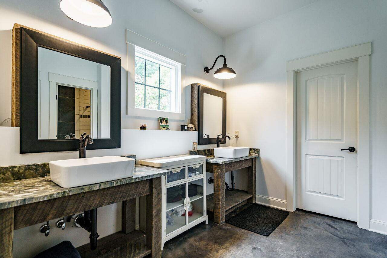 4709 Bountiful Lane Apex, NC 27539 - Photo 25 of 30 a spacious bathroom with a granite countertop sink and a mirror