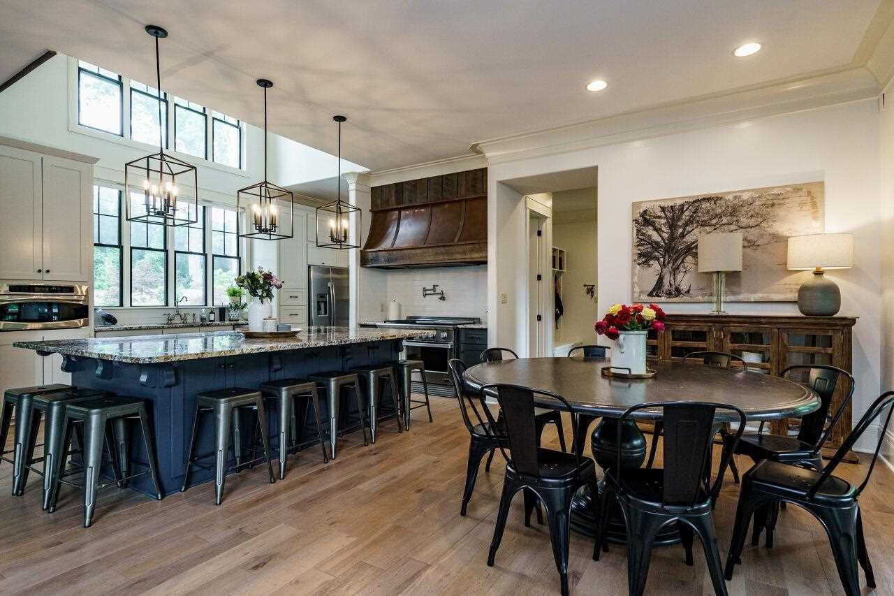 4709 Bountiful Lane Apex, NC 27539 - Photo 6 of 30 a view of a dining room with furniture and wooden floor