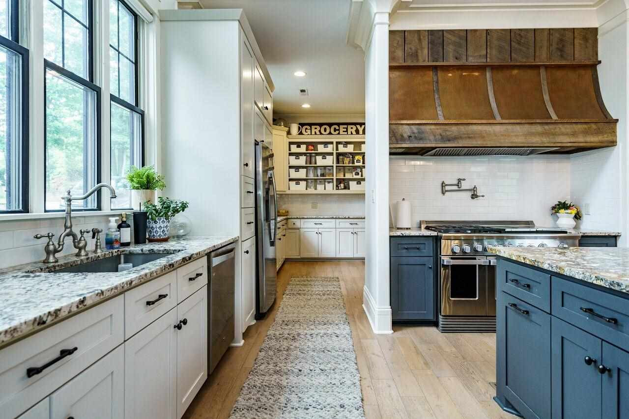 4709 Bountiful Lane Apex, NC 27539 - Photo 8 of 30 a kitchen with stainless steel appliances granite countertop a stove and a sink