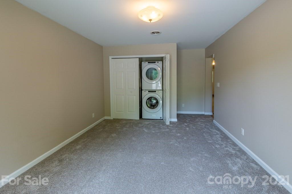 171 North Ridge Point, Unit V3 Sylva, NC 28779 - Photo 8 of 29 an empty room with closet and mirror